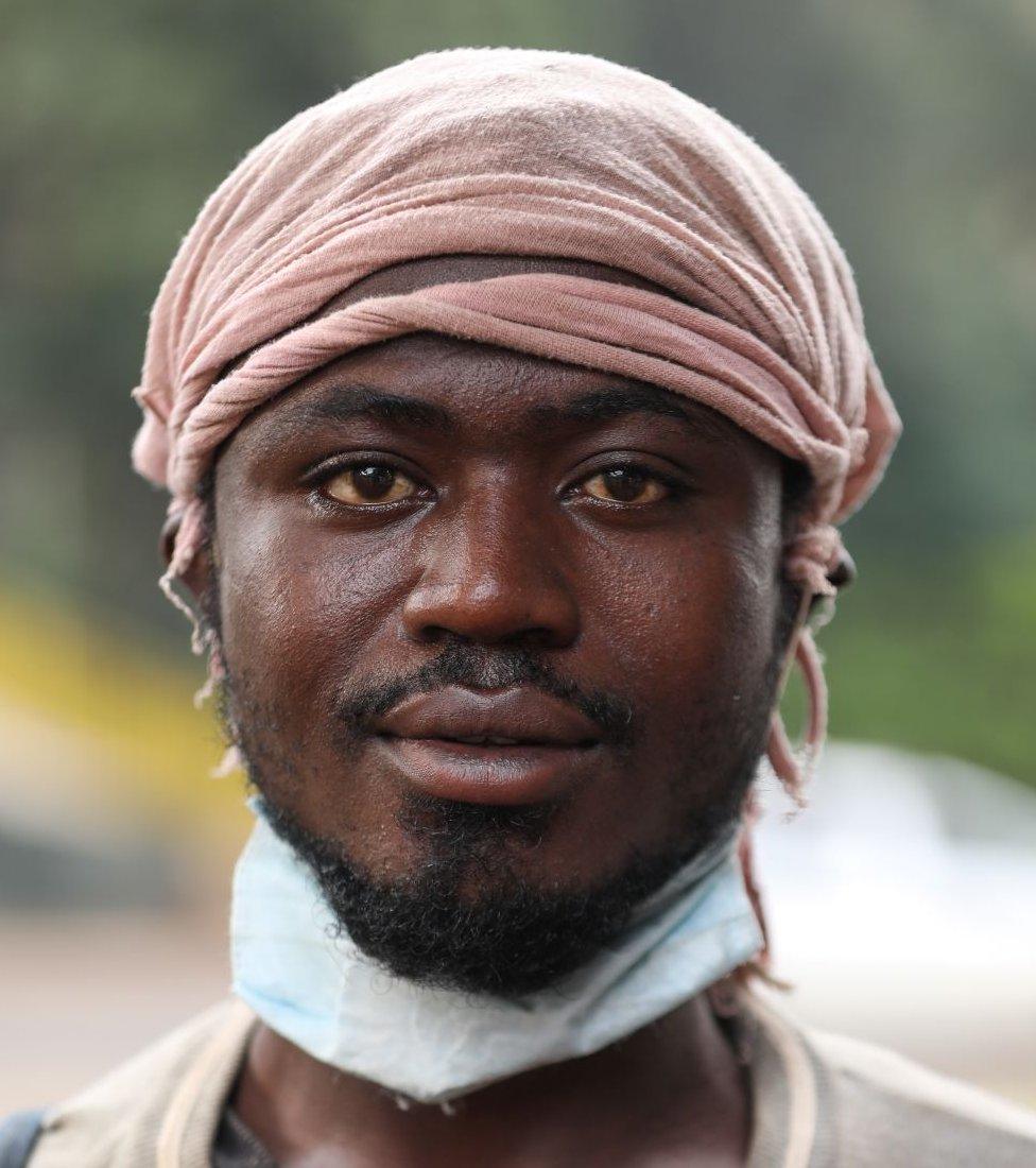 A Burundian refugee Bazira Afros, 26yrs old, who fled his country due to election violence, poses for a photo next to a footbridge where he and other refugees sleep next to a highway, ahead of World Refugee Day in Nairobi, Kenya, 19 June 2020.