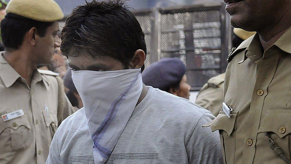 Indian police officials escort Pawan Gupta, one of those convicted in the Delhi gangrape case, to an appearance at the High Court in New Delhi on September 24, 2013