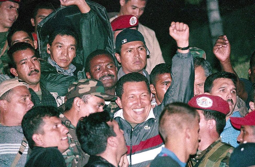 Venezuelan President Hugo Chavez returns to office two days after he was ousted from the Palace of Miraflores and arrested by the military in Caracas, Venezuela on April 13, 2002 - Thousands of protestors still thronged the streets, but in a first step toward reconciliation Chavez made conciliatory moves toward the state oil monopoly (Photo by Pedro RUIZ/Gamma-Rapho via Getty Images)