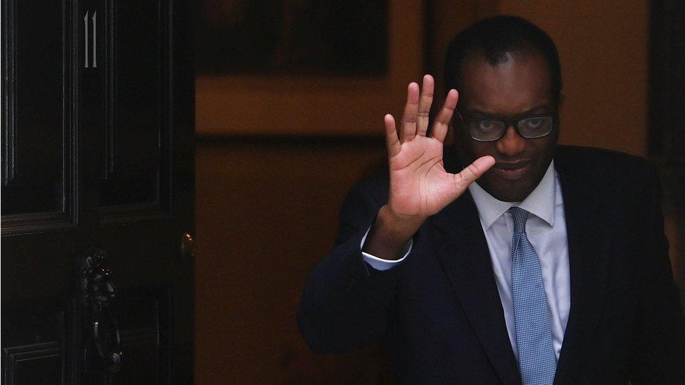 Kwasi Kwarteng waves as he leaves Downing Street