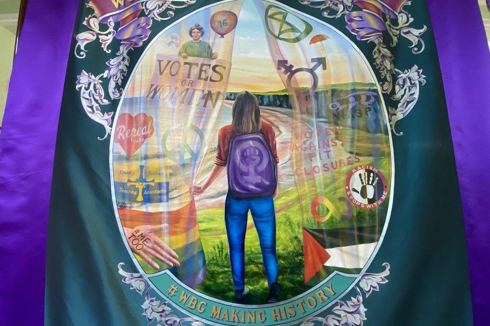 Reverse of the banner showing a young woman surrounded by campaign logos on a beach