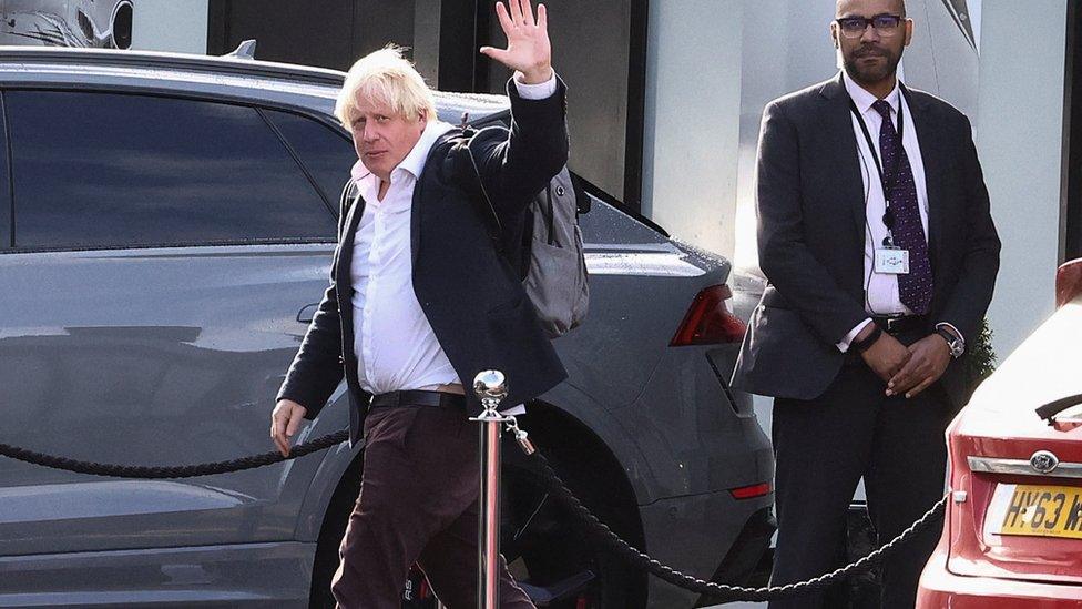 Former British Prime Minister Boris Johnson gestures, at Gatwick Airport,