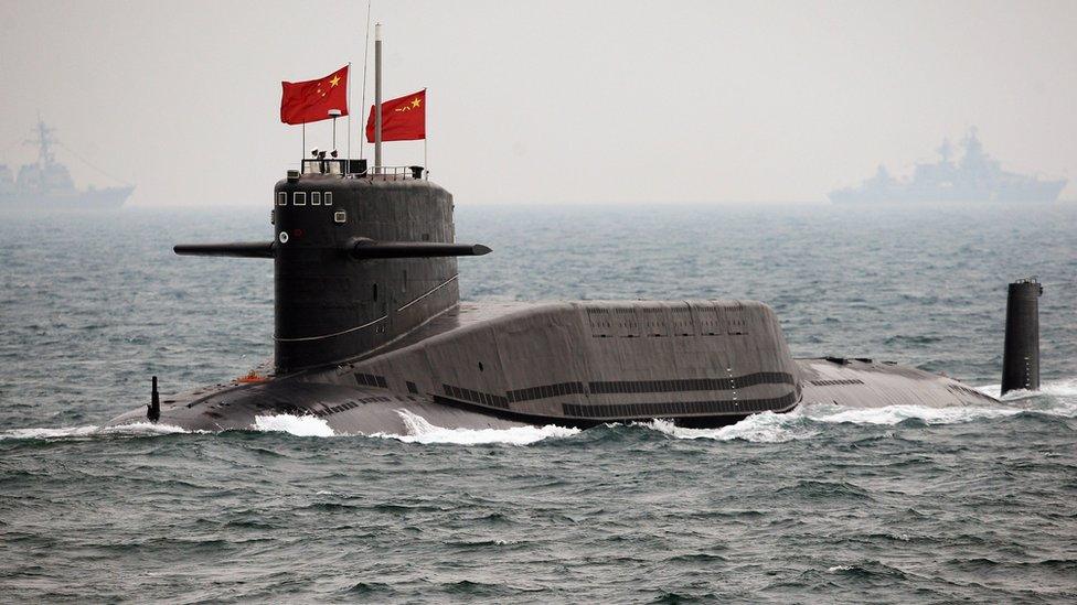 A Chinese Navy submarine attends an international fleet review to celebrate the 60th anniversary of the founding of the People's Liberation Army Navy on 23 April 2009, off Qingdao in Shandong Province.