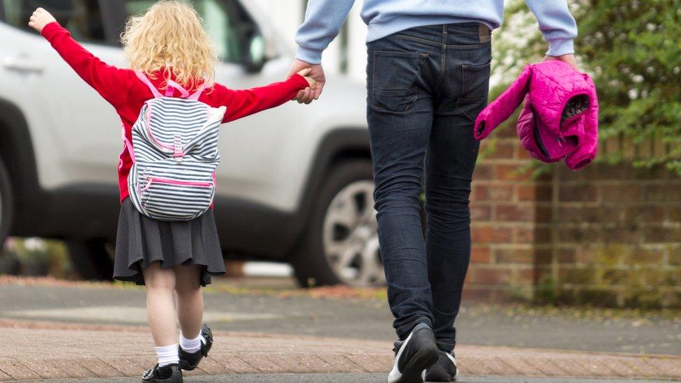 Dad and little girl walking