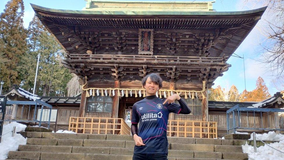 Ryo Kikuchi outside a Japanese temple