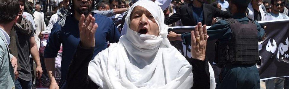 Afghan protesters shout anti-government slogans during a protest against the government