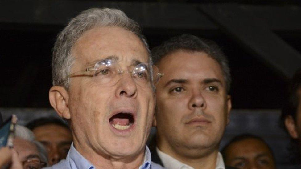 Opposition Senator and former President Alvaro Uribe reads a statement at his house in Rionegro, Colombia, Sunday, Oct. 2, 2016. Colombians rejected a peace deal with leftist rebels by a razor-thin margin in a national referendum.