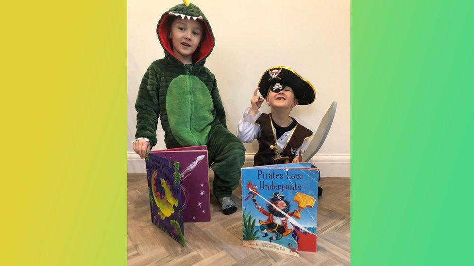 Charles and Oscar dressed as a dinosaur and a pirate