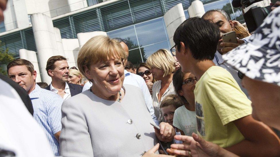 German Chancellor Angela Merkel greets members of the public in Berlin (28 Aug)