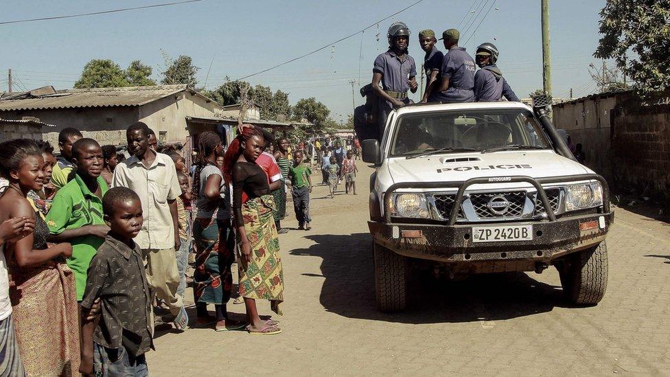 Zambian police patrol near the Chawama Compound where residents attacked and looted foreign-run shops in Lusaka - 19 April 2016