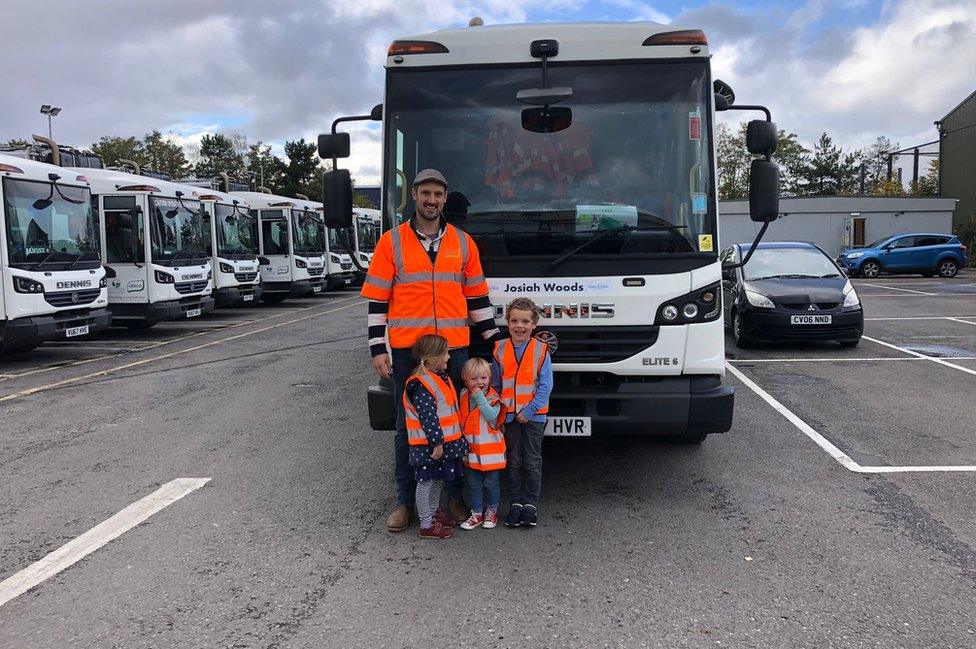 Josiah and siblings in front of bin lorry