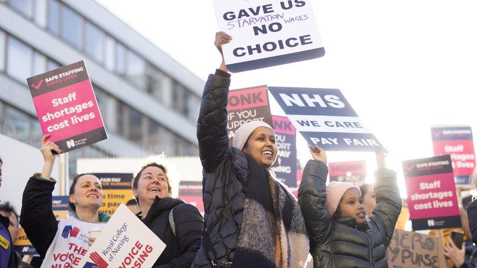 Picket line supporters with placards