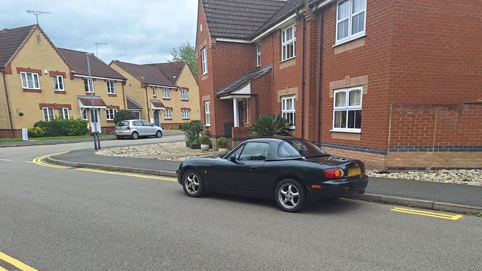 Car parked between double yellow lines in Witchford