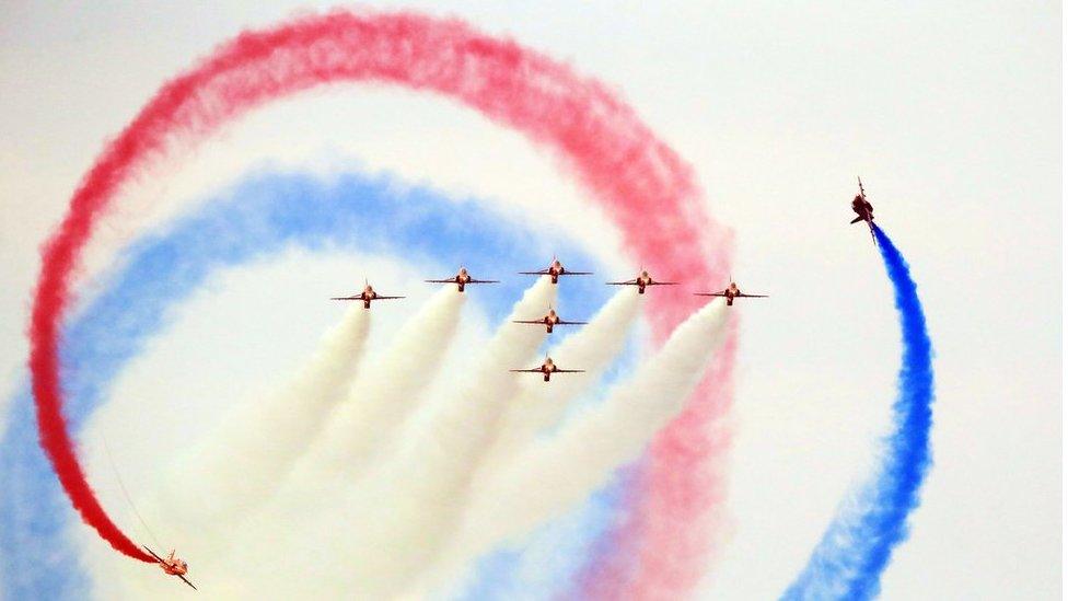 Red Arrows performing at the Sunderland International Airshow with coloured smoke in the sky