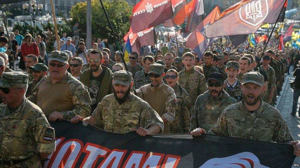 Members and supporters of Right Sector and other ultra-right political parties hold poster with slogan"Freedom to political prisoners" as they march during a protest in downtown Kiev, Ukraine, 3 July 2015.