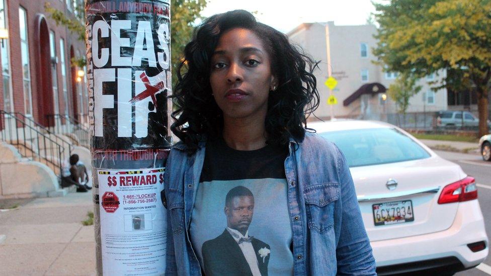 Brittany Oliver stands near the spot where her uncle, David Lamont Hill, was shot to death a year ago