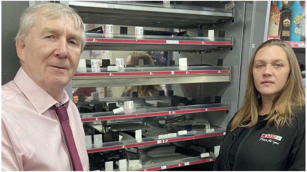 Andrew and Susan Connolly owners of the Spar store in Pewsey standing in front of the empty cigarette cabinet