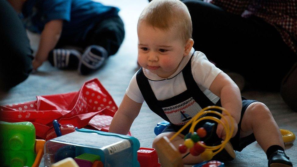 George playing with toys