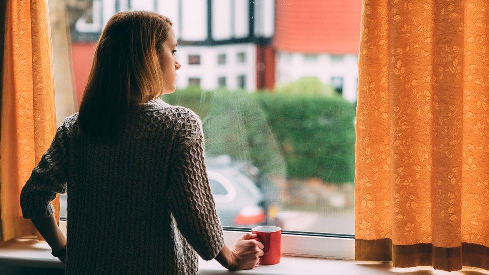 Woman looking out of a window