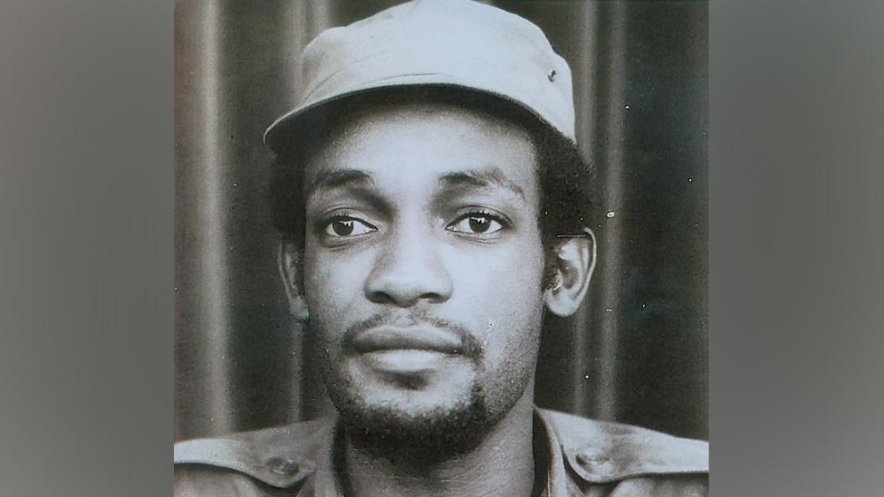 Black and white portrait of a man in a cap