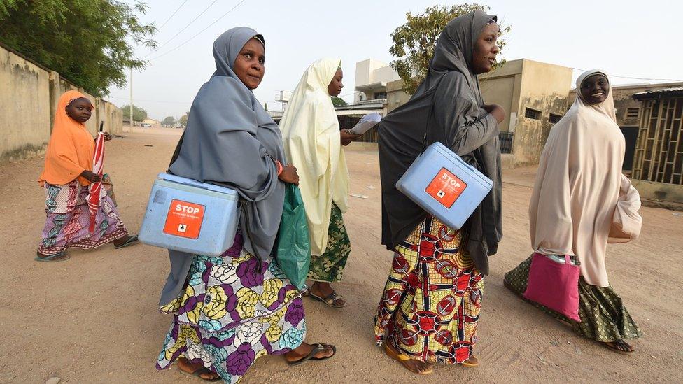 Female health workers on a drive to vaccinate children against polio in Nigeria's Kano state