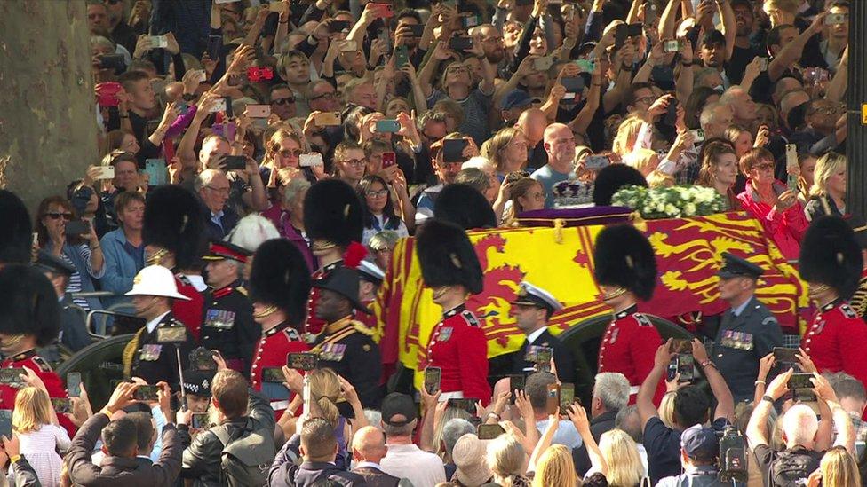 Crowds taking photos of the procession