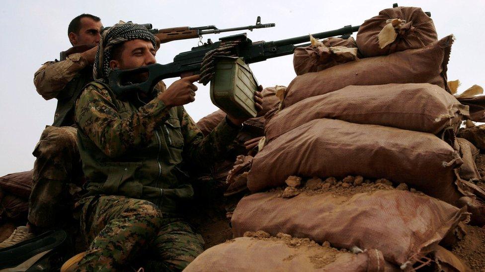 Kurdish Peshmerga fighters take aim during a battle with Islamic State militants at Topzawa village, near Bashiqa, Iraq (24 October 2016)