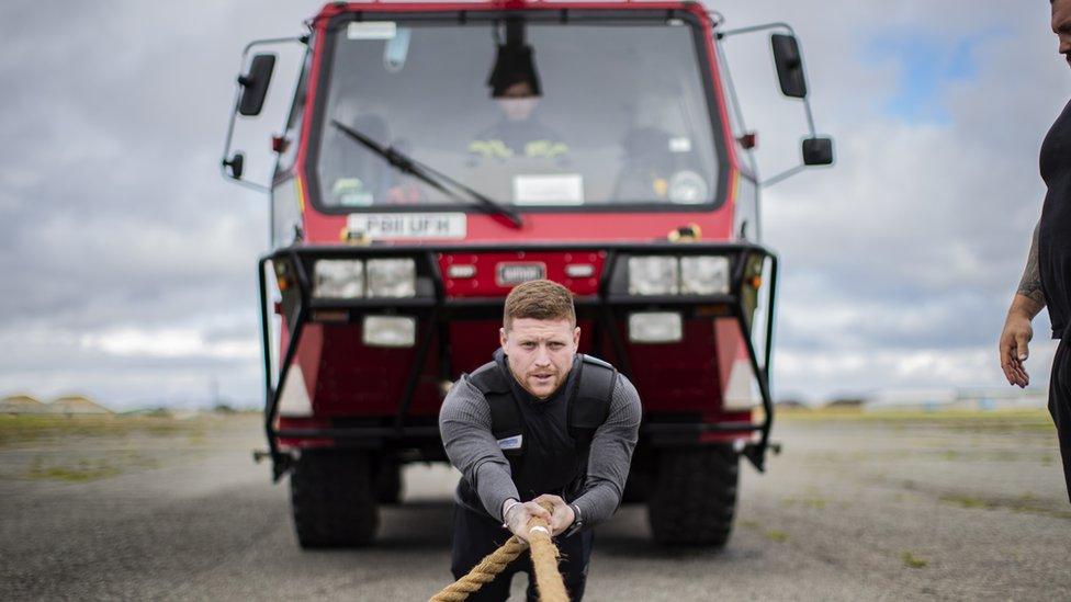 Ethan pulling a heavy truck during training