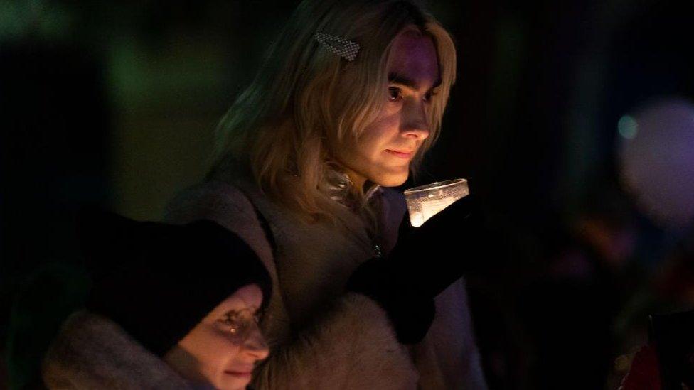 People attend a vigil in Sackville Gardens in Manchester