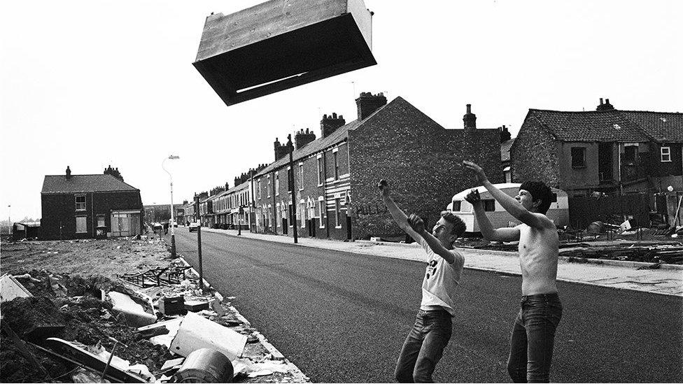 Boys throwing a sideboard