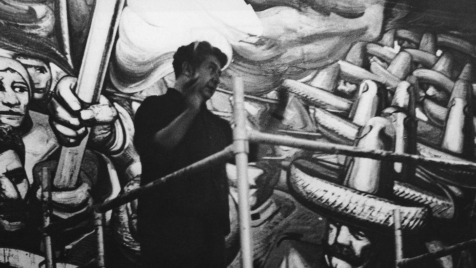 Mexican artist David Alfaro Siqueiros working on a mural in the Hall of the Revolution in Chapultepec Castle, circa 1960