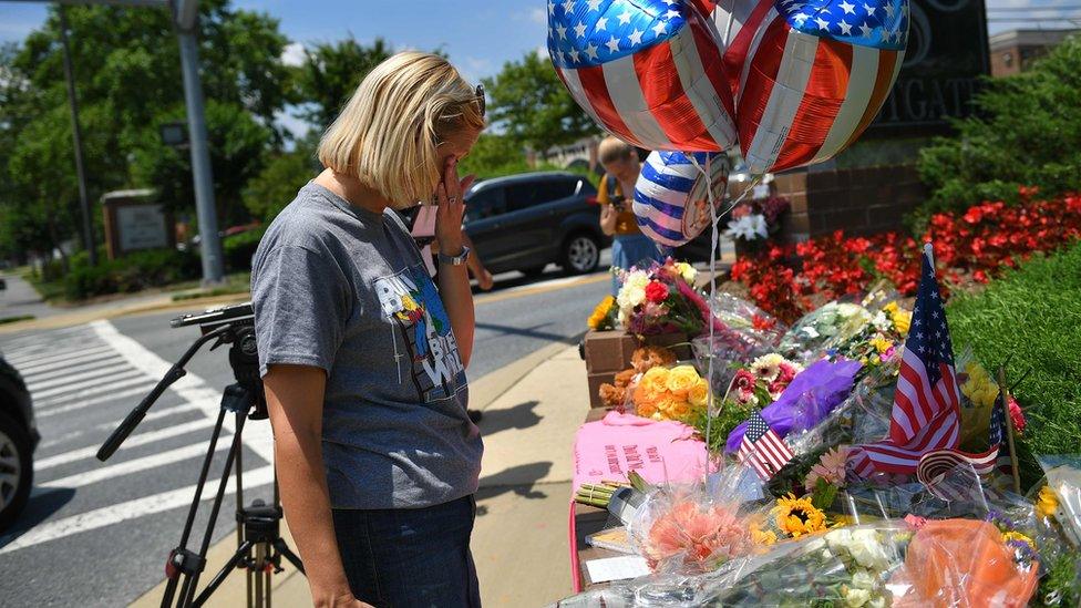 Christine Feldmann of Annapolis, who knew some of the shooting victims, stands before a makeshift memorial to victims of the Capital Gazette newspaper attack