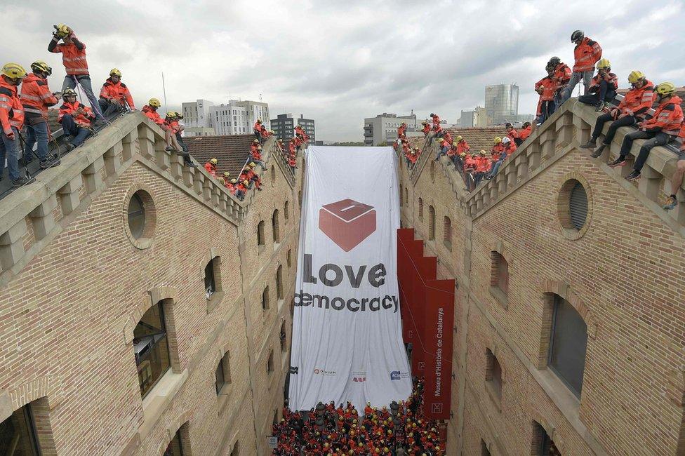 Firefighters show off a pro-referendum banner in Barcelona, 28 September