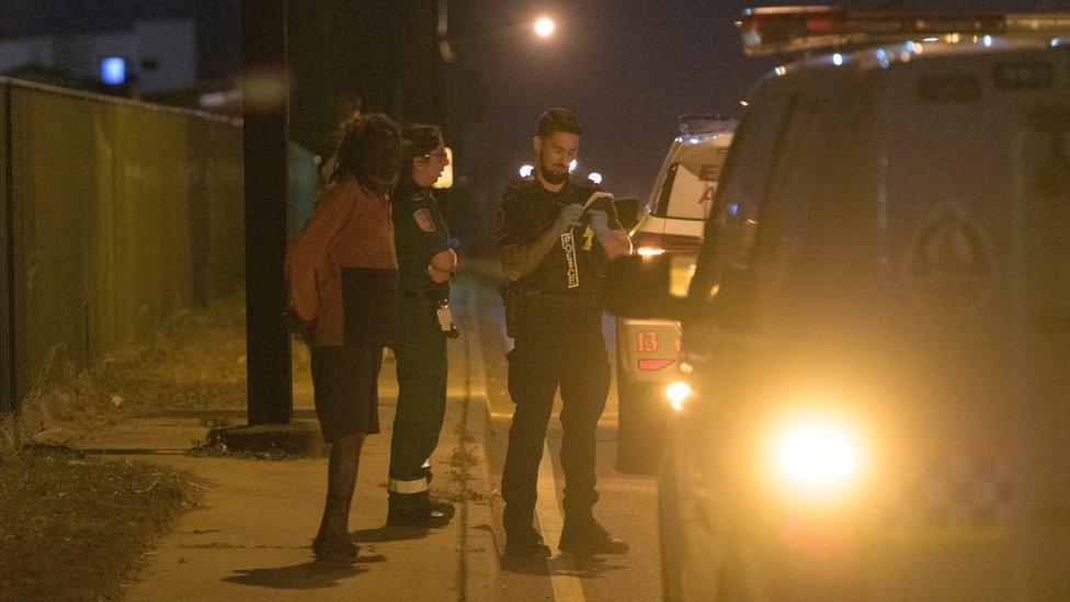 Police outside an industrial compound in the suburb of Woolner where some of the shootings took place