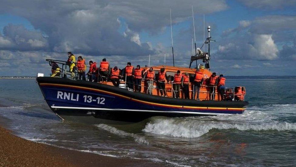 A group of people thought to be migrants are brought in to Dungeness, Kent, by the RNLI