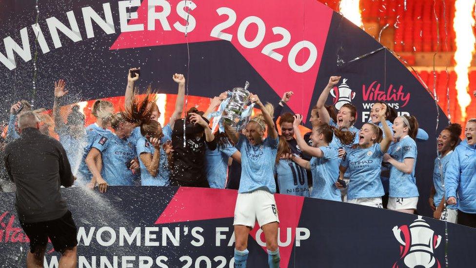 Manchester City celebrating with the FA Cup trophy at Wembley