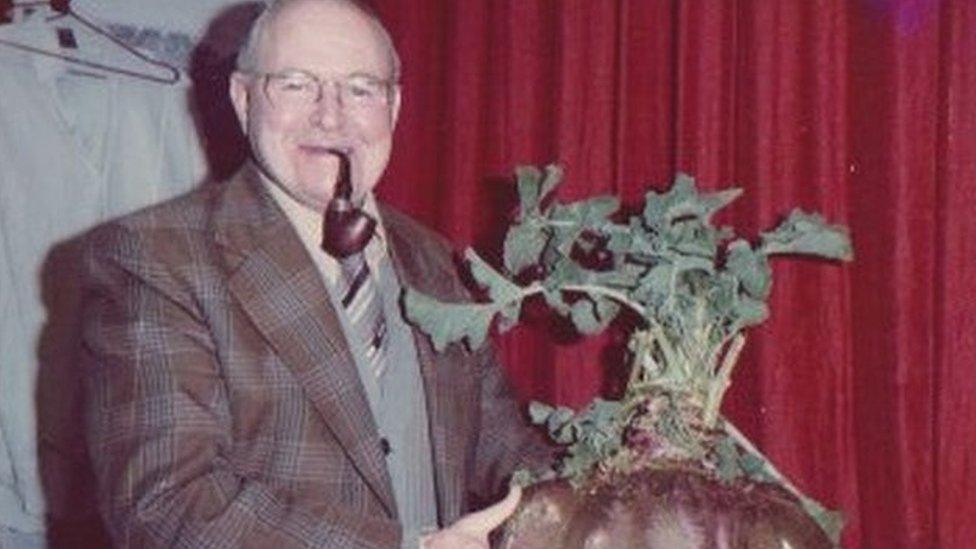 Man holding giant swede