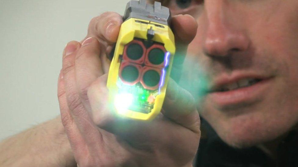 Police officer using new Taser