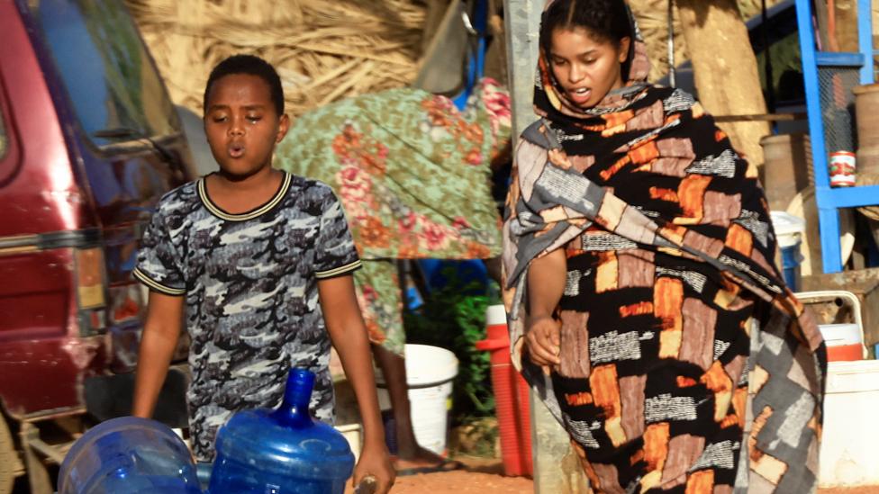 People look for water during clashes between the paramilitary Rapid Support Forces and the army in Khartoum North, Sudan - 20 April 2023