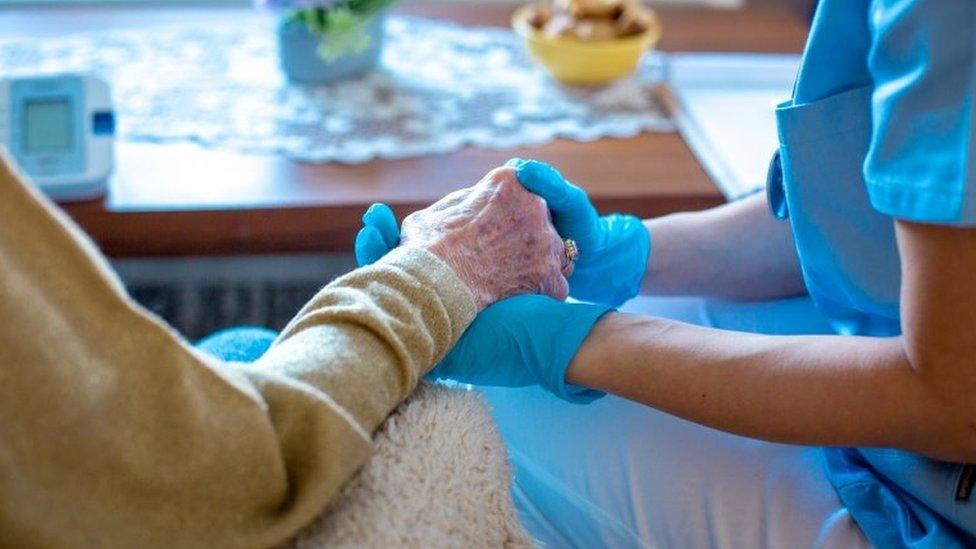 Doctor holds patients hand