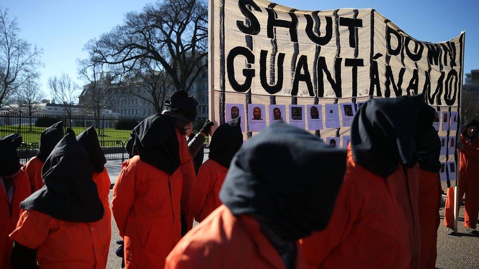 Protestors with signs - they want to close Guantanamo