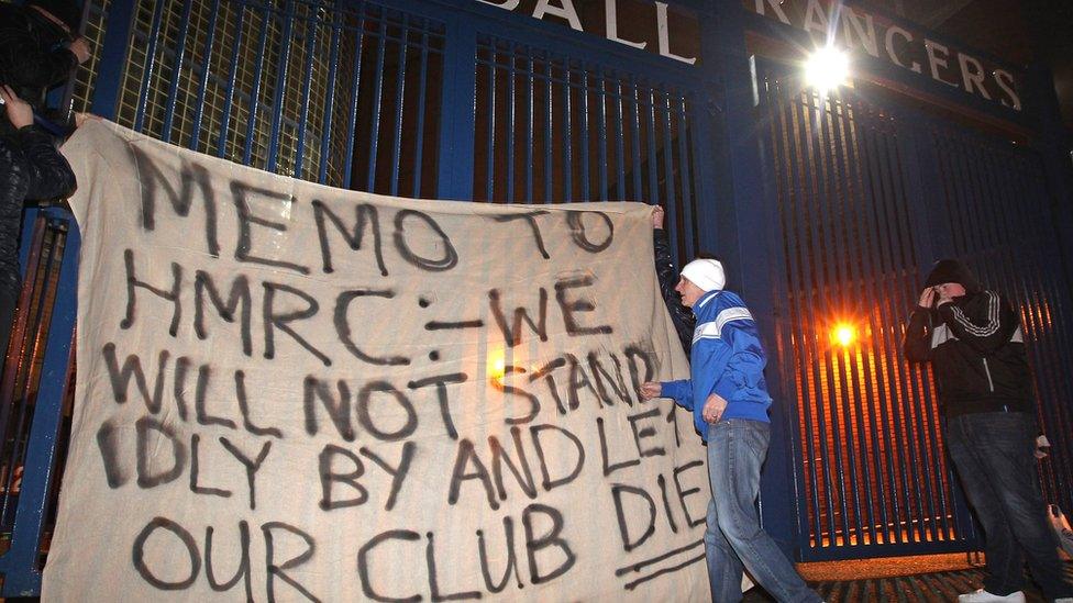 Fans raise a banner on the gates of Ibrox Stadium on February 14, 2012 in Glasgow, Scotland