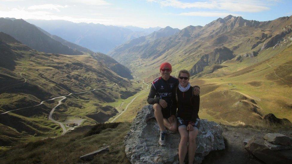 Dan and Esther pose for a picture next to a valley