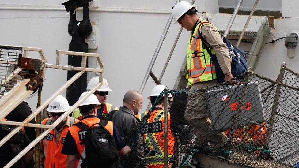 Officials from the Transportation Safety Board (TSB) of Canada board the Polar Prince, the main support ship for the Titan submersible, after it arrived at the Port of St. John's in Newfoundland