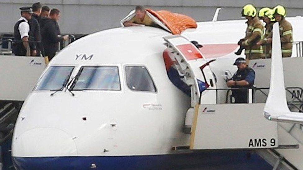 James Brown lying on plane as police and fire-fighters watch on