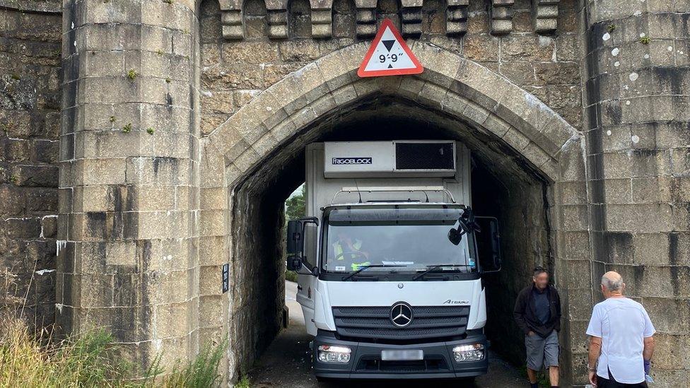 Lorry stuck under bridge