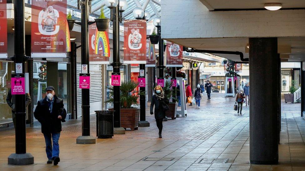 People walk in the town centre of Burnley amid the outbreak of Covid-19, in Burnley