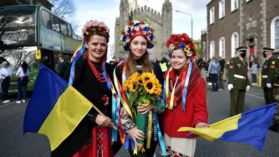 Members of the local Ukrainian community pose for a photo with Ukrainian flags as Dubliners prepare to celebrate St Patrick's Day on March 17, 2022 in Dublin, Ireland. St Patrick's Day celebrations return to the streets of Dublin after a two-year absence, due to the Covid-19 pandemic.