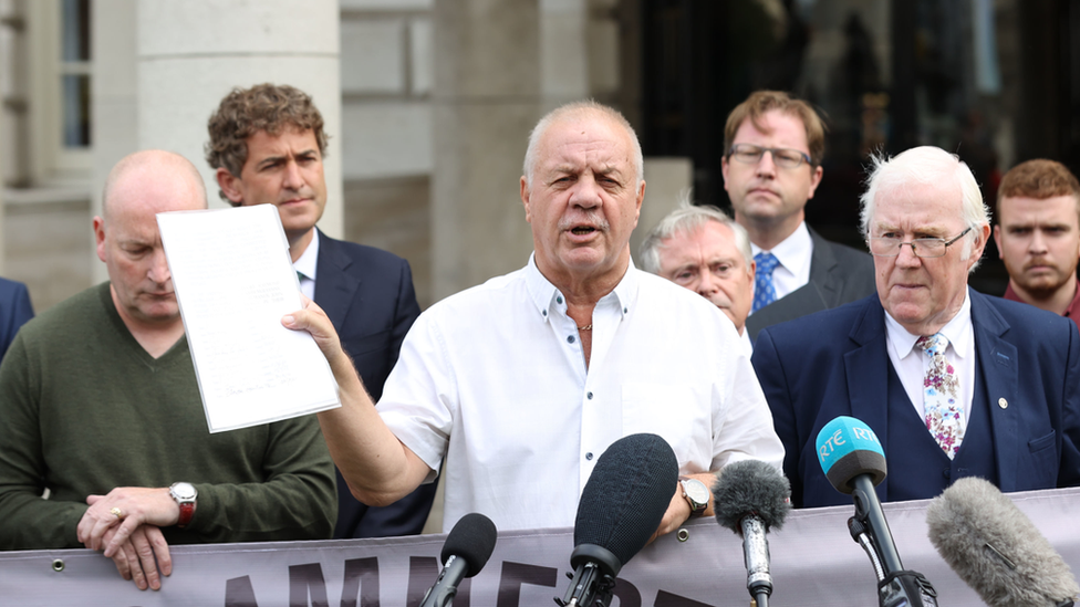 Campaigner Raymond McCord (centre) said the government had "no choice" but to listen to their opposition to the plan