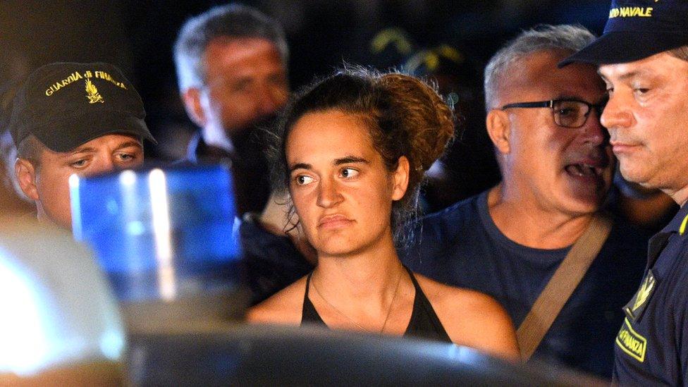 Sea-Watch 3 captain Carola Rackete, 31, is escorted off the ship by police and taken away for questioning in Lampedusa, Italy, 29 June 2019